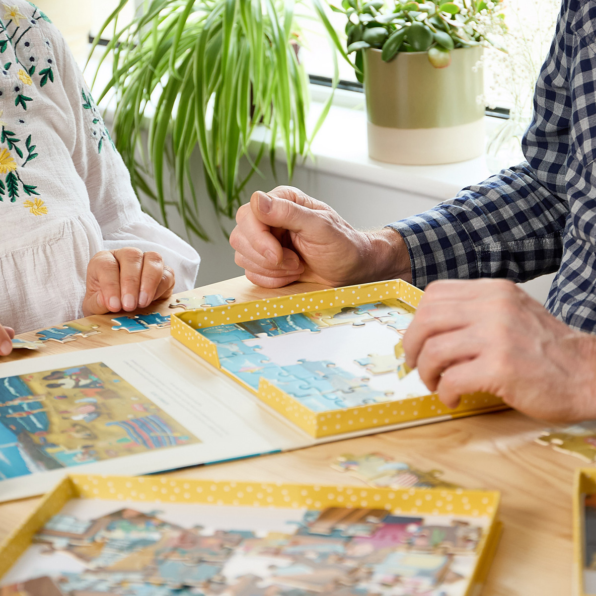 Two people completing a large-piece jigsaw puzzle together