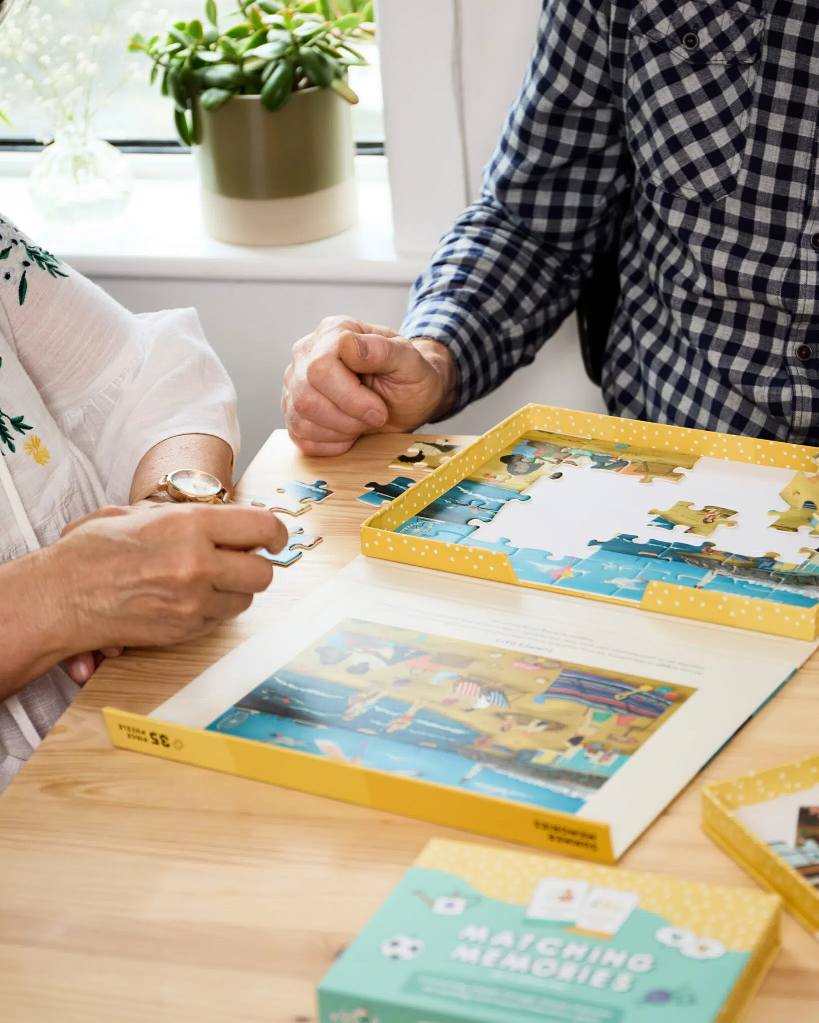 People sharing a jigsaw puzzle at a table