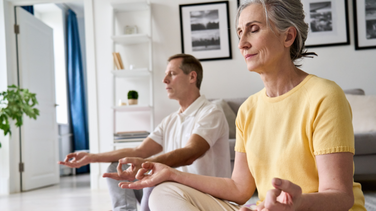 Older couple taking part in a meditation to boost wellbeing as an activity for people with dementia