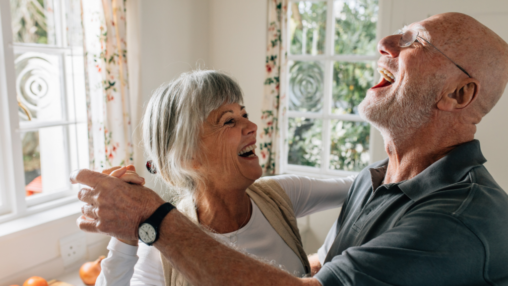 Couple dancing and laughing - singing and dancing can be fantastic activities for dementia
