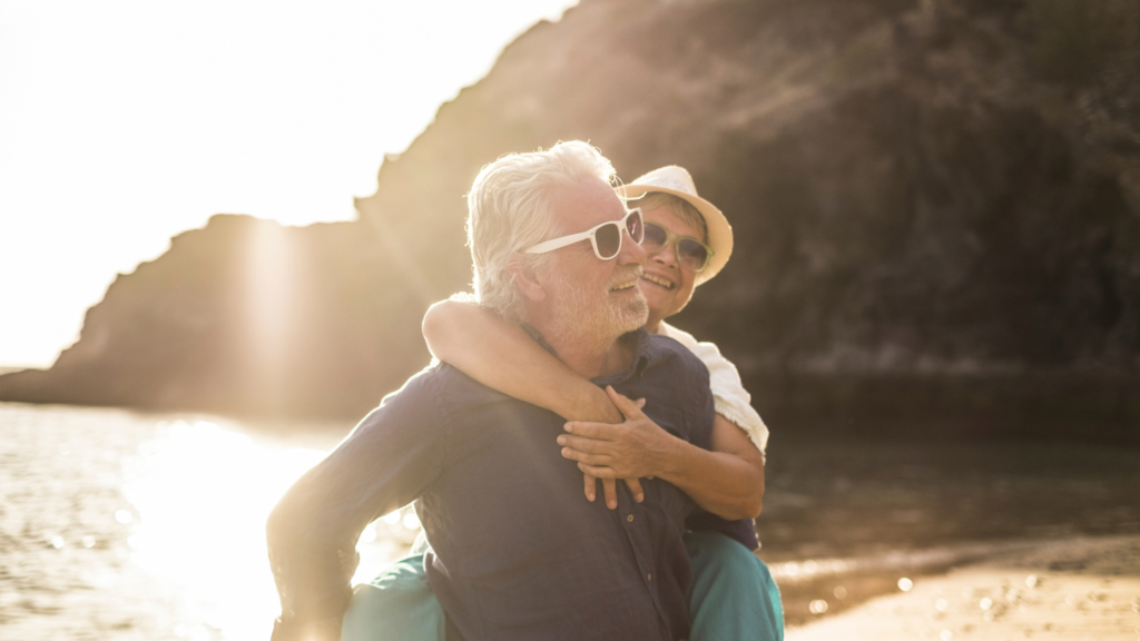 older couple visiting a beach for a dementia friendly seaside day out