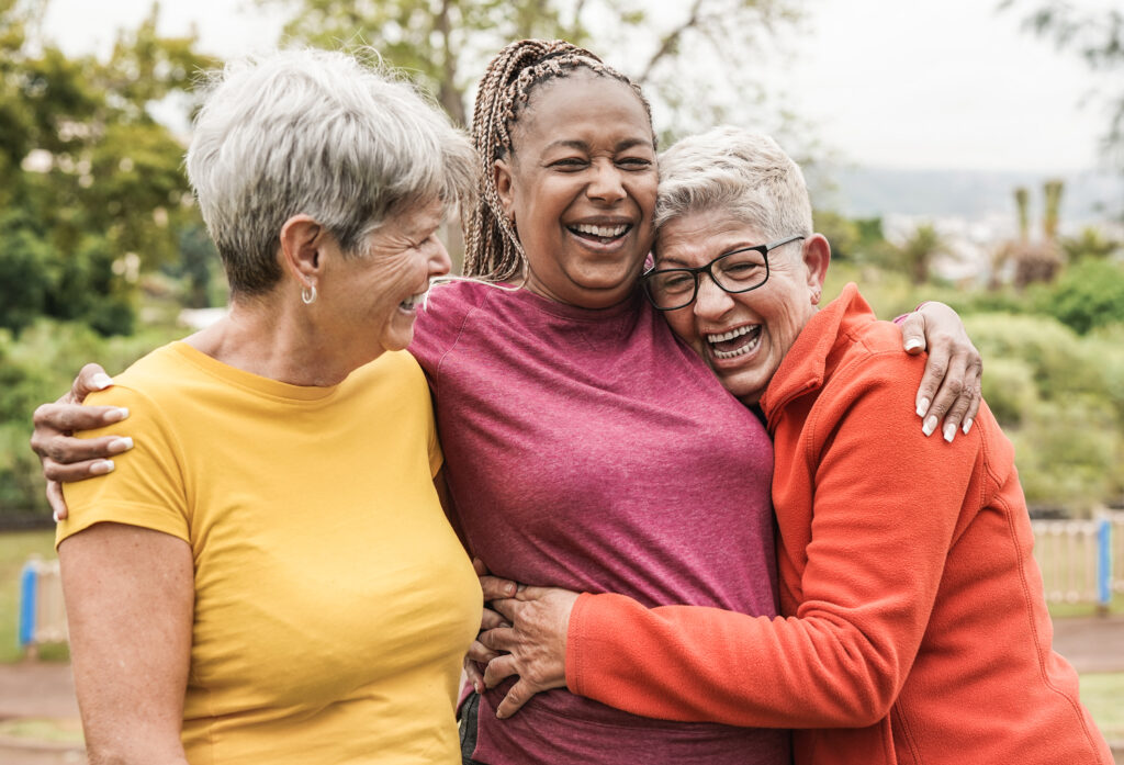 three happy women outdoors enjoying one of many free activities for people with dementia indoors and outdoors