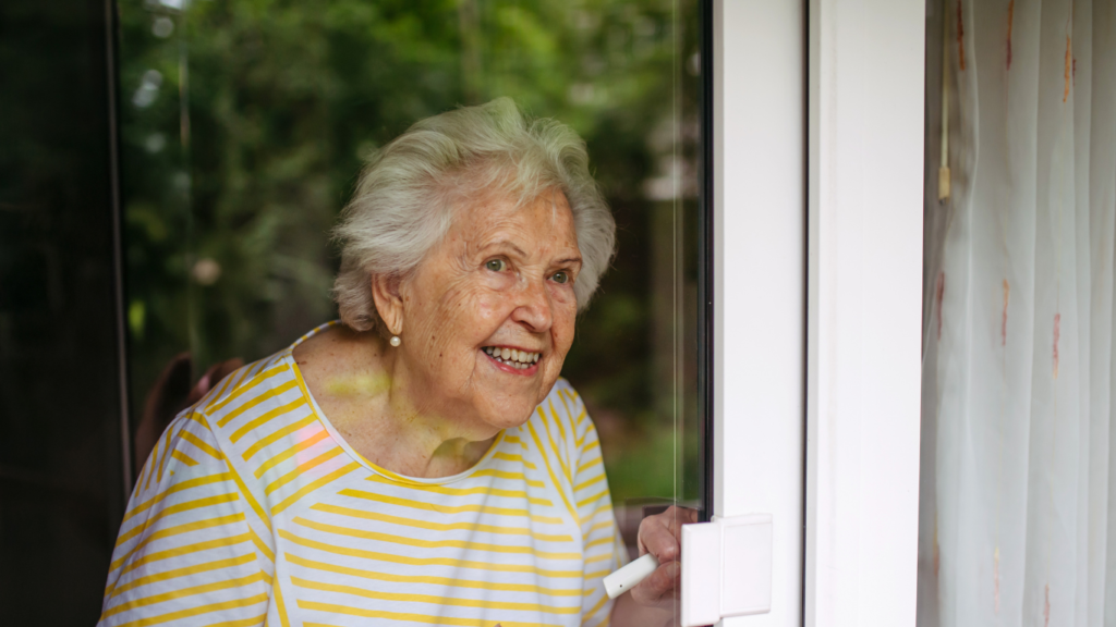 woman looking out of window to demonstrate spring dementia tips include watching the changes in nature from the window