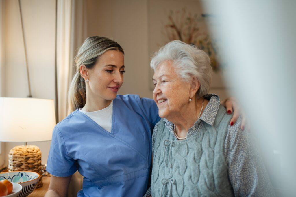 care home worker supporting resident to manage feelings of anxiety in dementia
