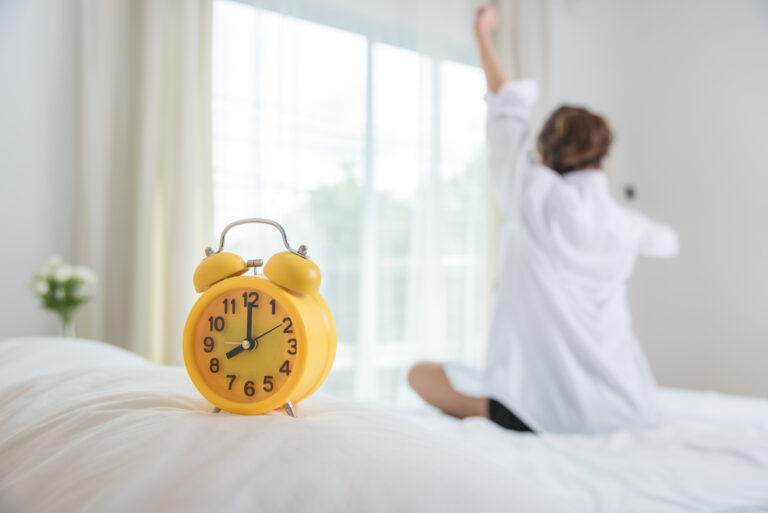 woman waking from restful sleep after learning how to manage sleep and dementia